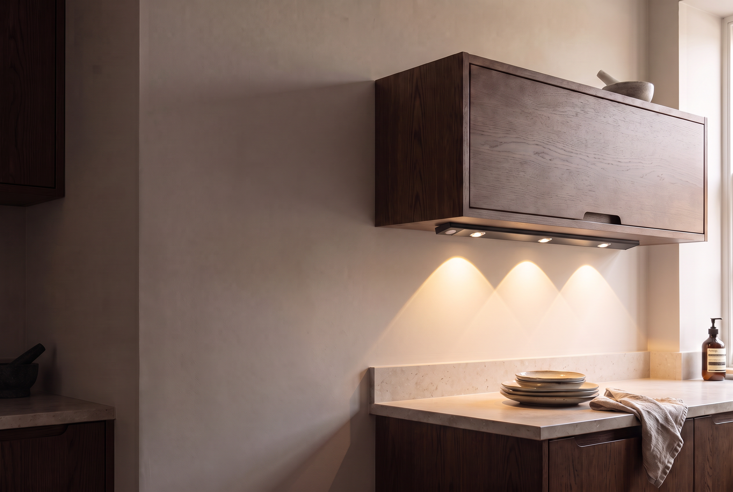 Black GlowSense light illuminating a stone worktop in a contemporary kitchen
